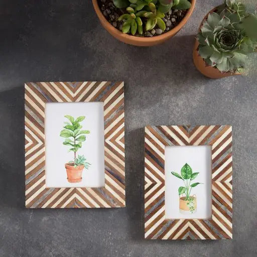 Two picture frames featuring a chevron pattern of wood, bone, and stone.