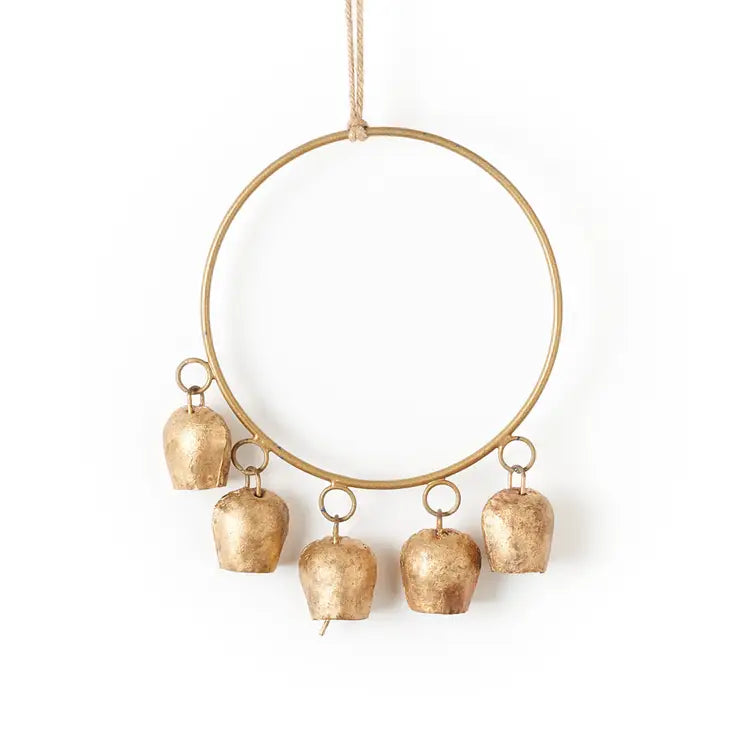 A circular brass wind chime hangs from a twine string. The chime has 5 rustic bells hanging from the center circle.